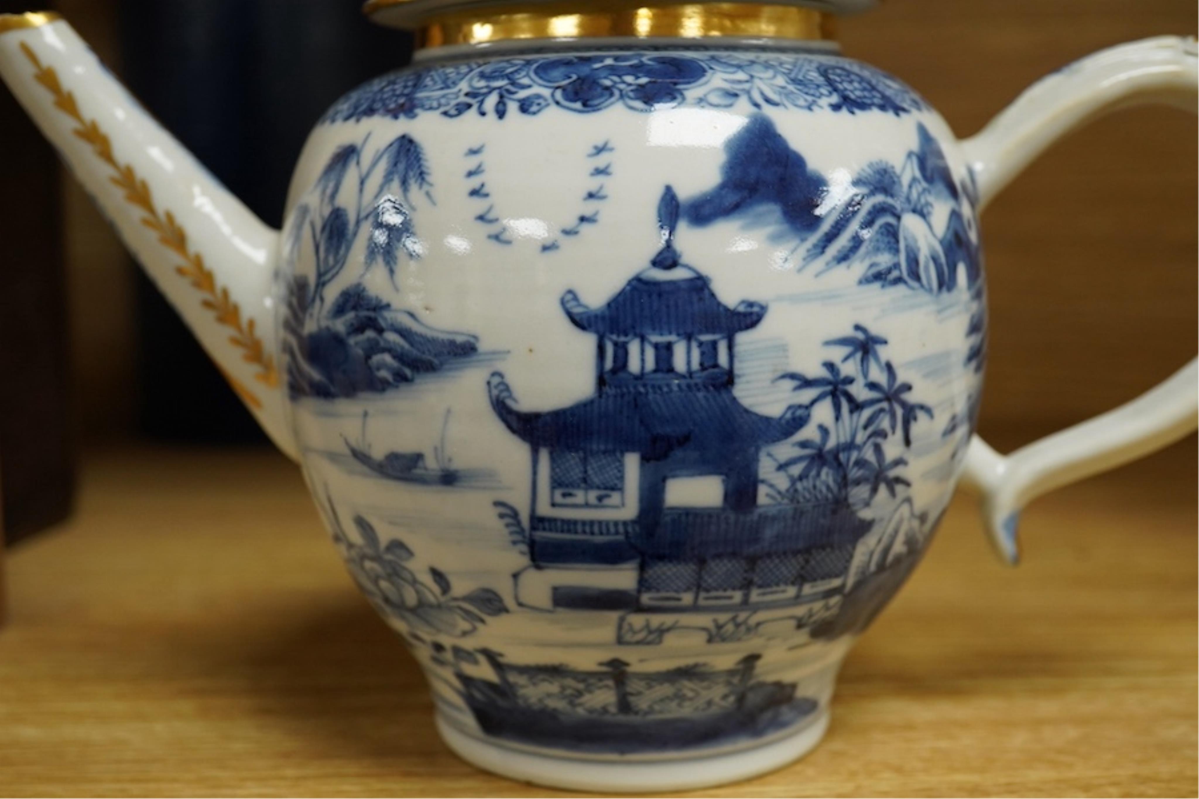 A Chinese export blue and white teapot, c.1790, painted with pagodas, 24cm wide. Condition - some chipping and firing cracks